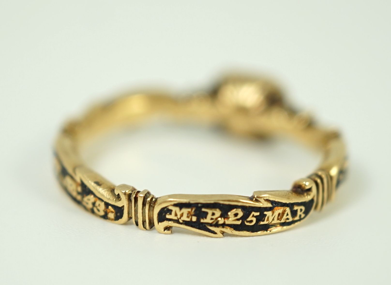 A George II gold, black enamel and rock crystal set mourning ring